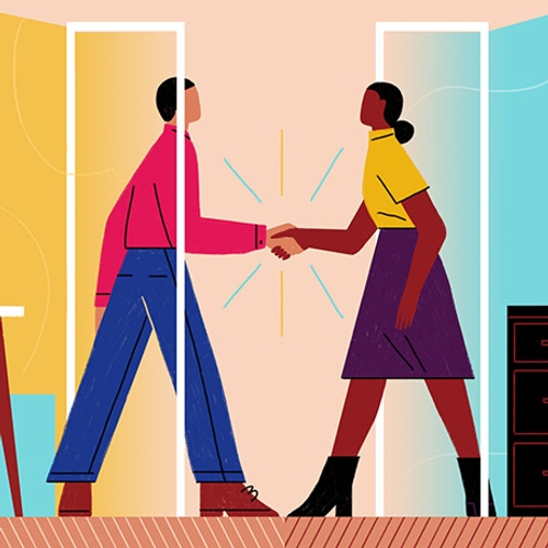 Two people finalize a deal with a handshake