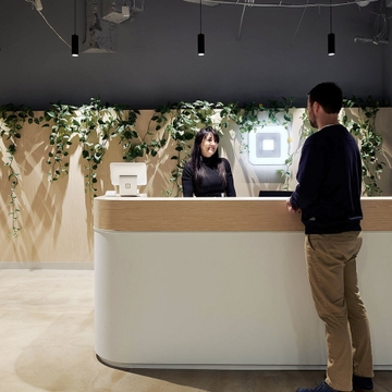 Square front desk engaging with colleague