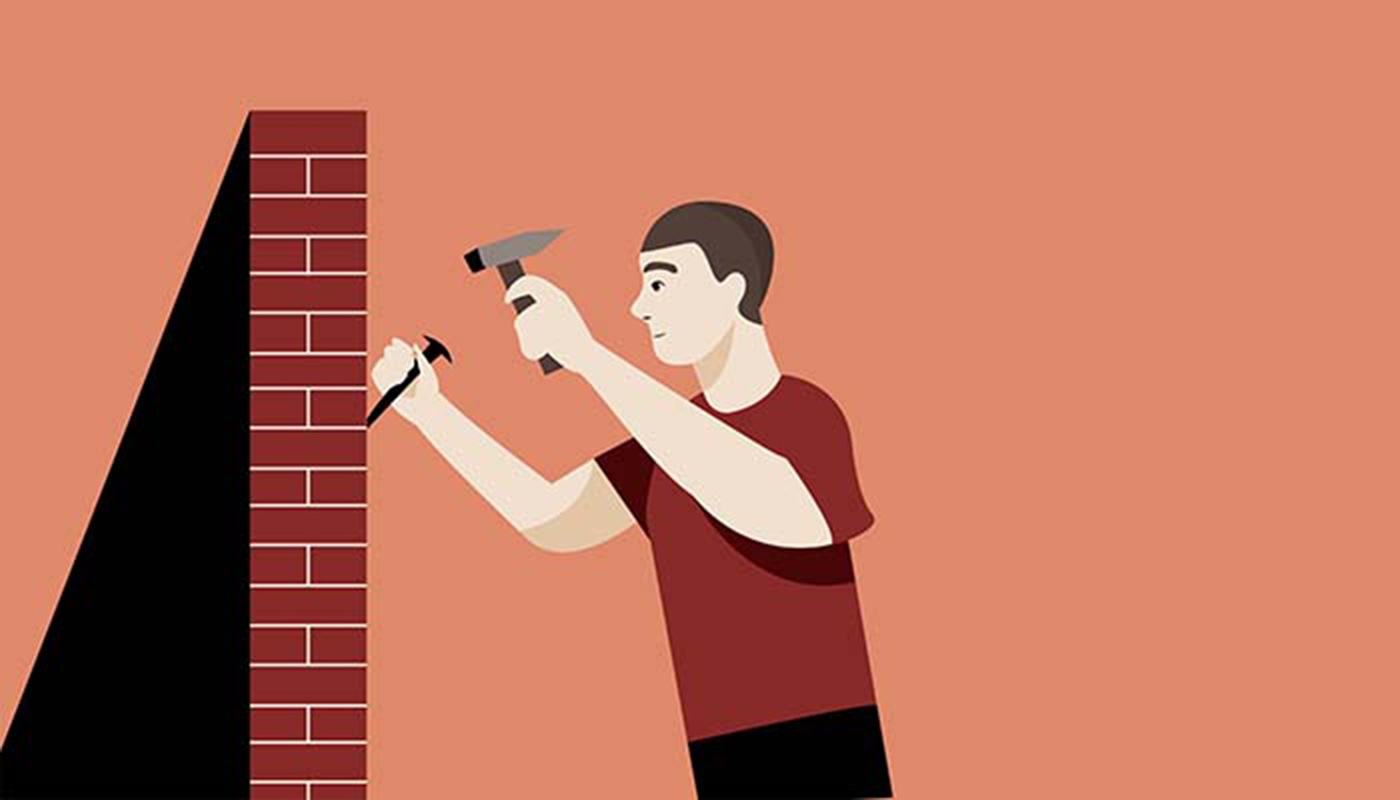 Man chipping away at building