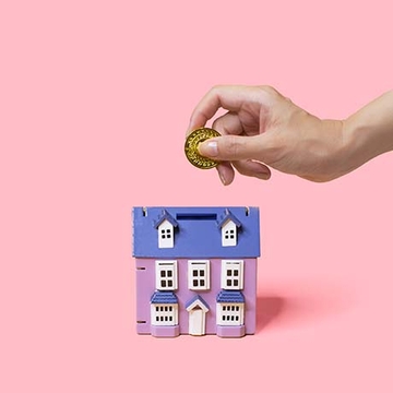 Moneybox with person placing coin inside