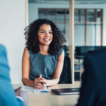 woman sitting across desk