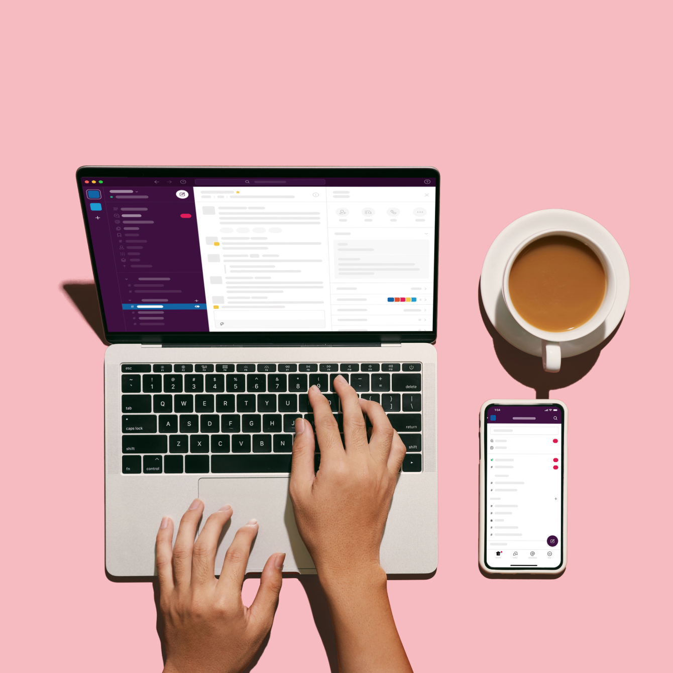 Computer screen with coffee and phone on table