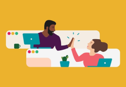 Co-workers with laptops giving each other high fives.