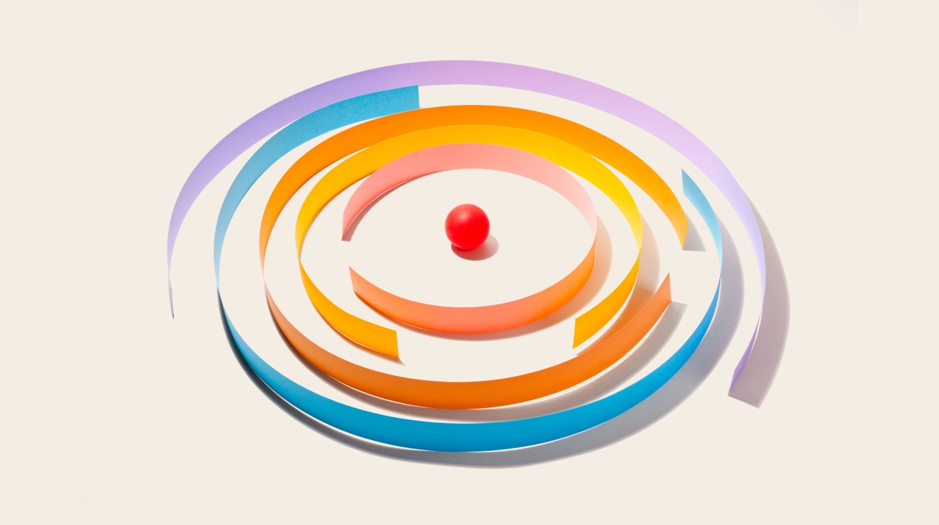 Red ball in the middle of a circle maze representing productivity